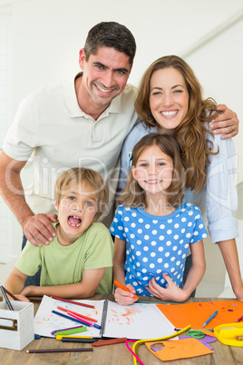 Parents with children drawing at table