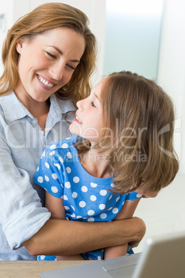 Affectionate mother embracing daughter