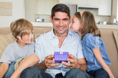 Father receiving gift from loving children