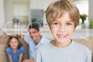 Boy smiling with family in background