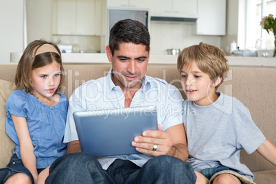 Family using digital tablet together