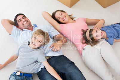 Family lying in their new house