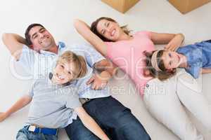 Family lying in their new house