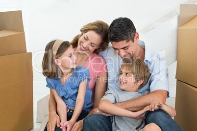 Happy family sitting in new house