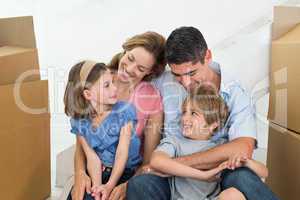 Happy family sitting in new house