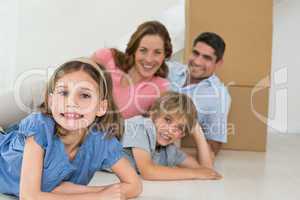 Happy family lying in their new house