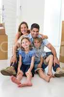Family sitting on floor in new house