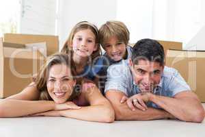 Family lying on floor in new house