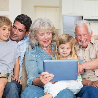 Smiling family using digital tablet