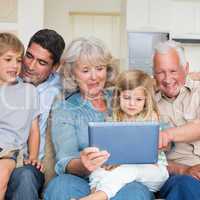 Smiling family using digital tablet