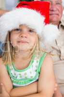 Girl wearing Santa hat at home