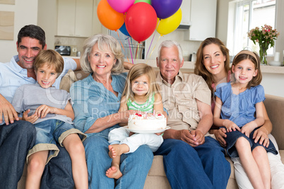 Multigeneration family celebrating girls birthday