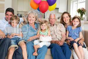 Multigeneration family celebrating girls birthday