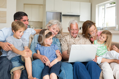 Multigeneration family using laptop in living room