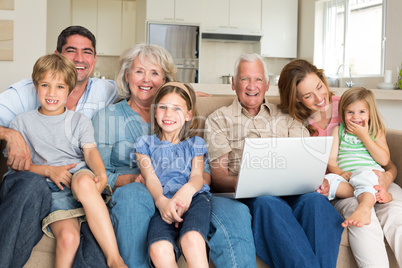 Cheerful family with laptop in living room