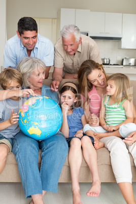 Family exploring globe in living room