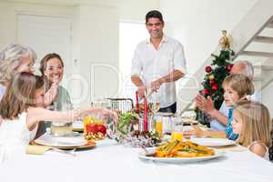 Family enjoying Christmas meal at dining table