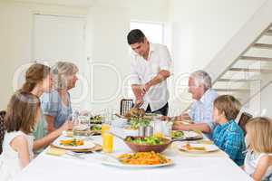 Father serving meal to family