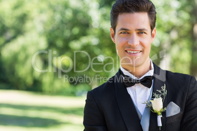 Confident groom in garden