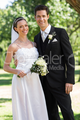 Newly wed couple standing in garden