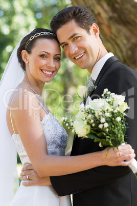 Happy newly wed couple in garden