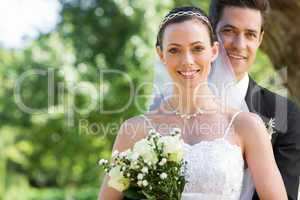 Smiling bride and groom in garden