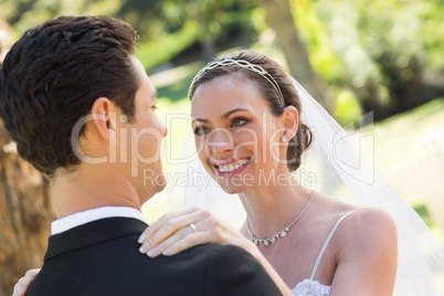 Bride looking at groom in garden