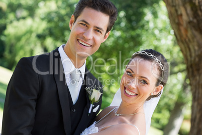 Happy young bride and groom in garden