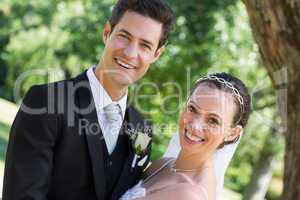 Happy young bride and groom in garden