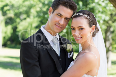 Newly wed couple smiling together in garden