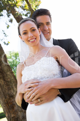 Bride and groom standing in garden