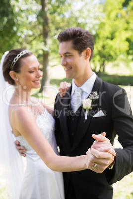 Bride and groom dancing while holding hands