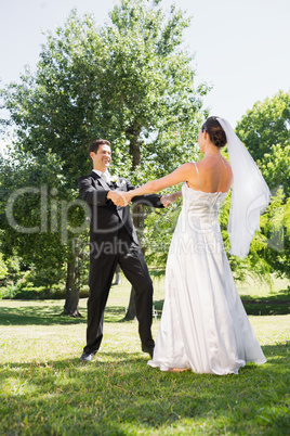 Bride and groom enjoying in park