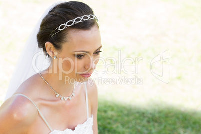 Thoughtful bride looking away in garden