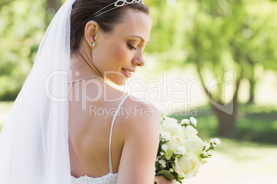 Rear view of bride with flowers in garden