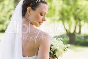 Rear view of bride with flowers in garden