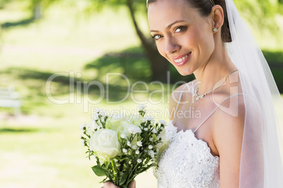 Closeup of bride with bouquet in garden