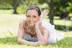 Attractive bride relaxing on grass