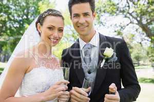 Newly wed couple holding champagne glasses