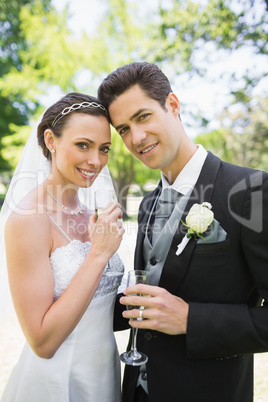 Beautiful bride and groom holding champagne flutes