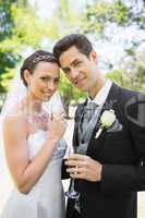 Beautiful bride and groom holding champagne flutes