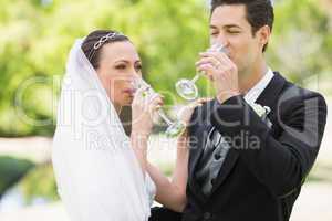 Newlywed couple drinking champagne