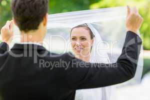 Groom unveiling his bride