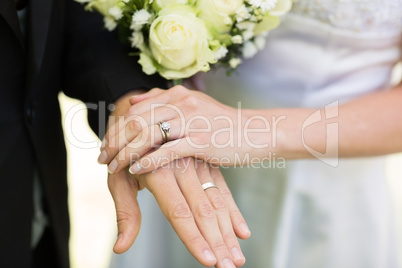 Bride and groom showing wedding rings