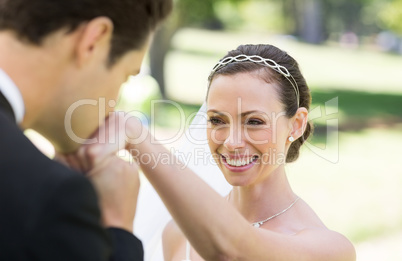 Groom kissing on hand of bride