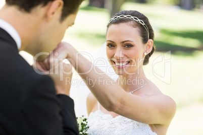 Groom kissing on hand of beautiful bride