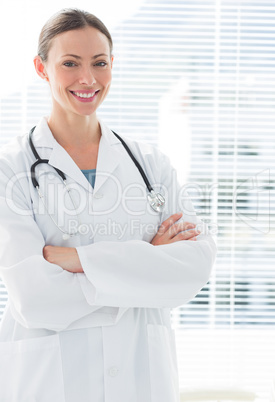 Confident female doctor standing arms crossed