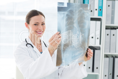Happy female doctor holding Xray report