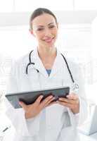 beautiful doctor holding digital tablet