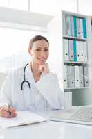 Doctor sitting at desk in clinic
